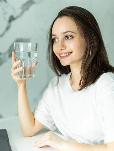 Home 1 pretty woman holds clean glass with water kitchen